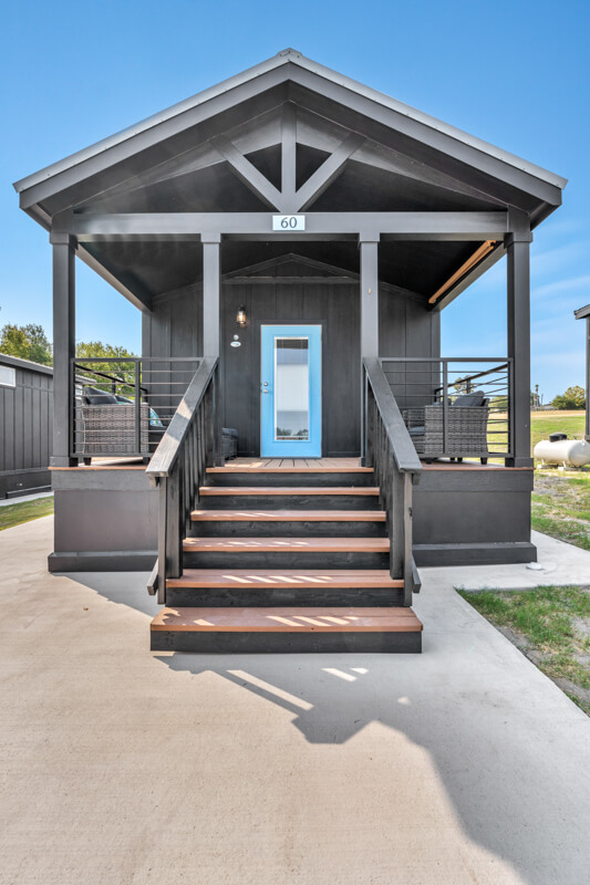 cozy lodging rental with stairs and front patio at a Resort in Brenham