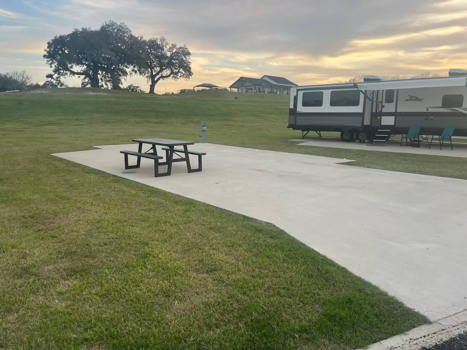 paved RV site with picnic table at sunset near Round Top, TX